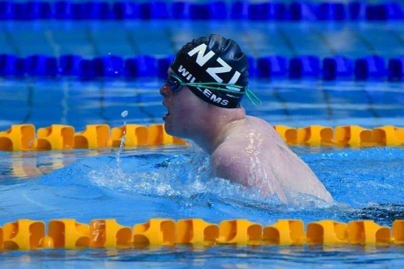 Luka in a swimming pool, with a NZ cap on