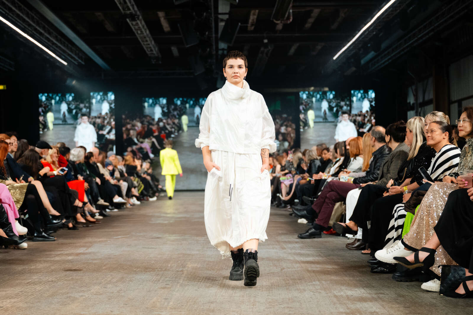 model wears white flowy dress and combat boots