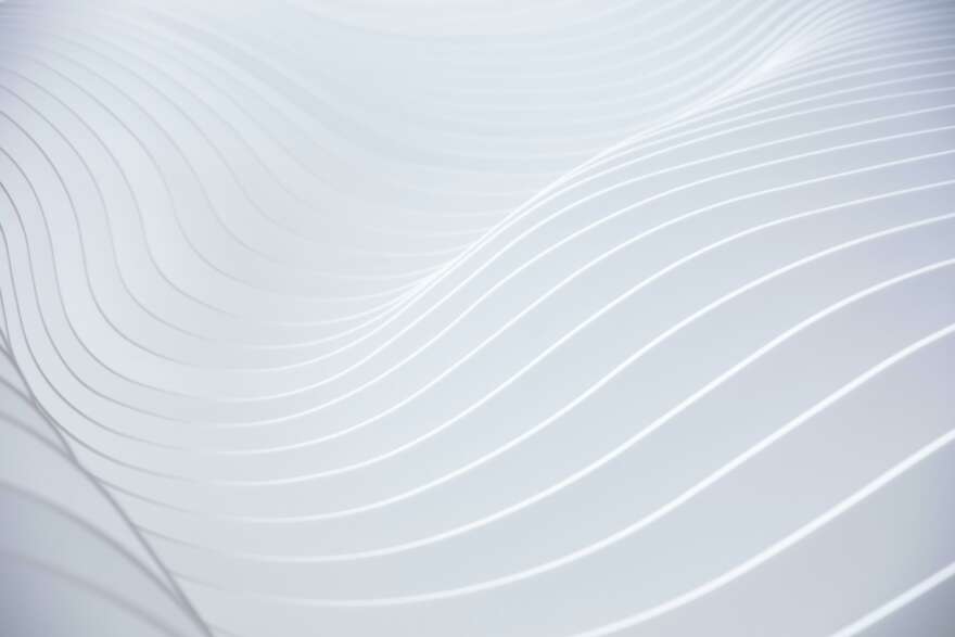 White graphic image showing various gradients of white in waves.