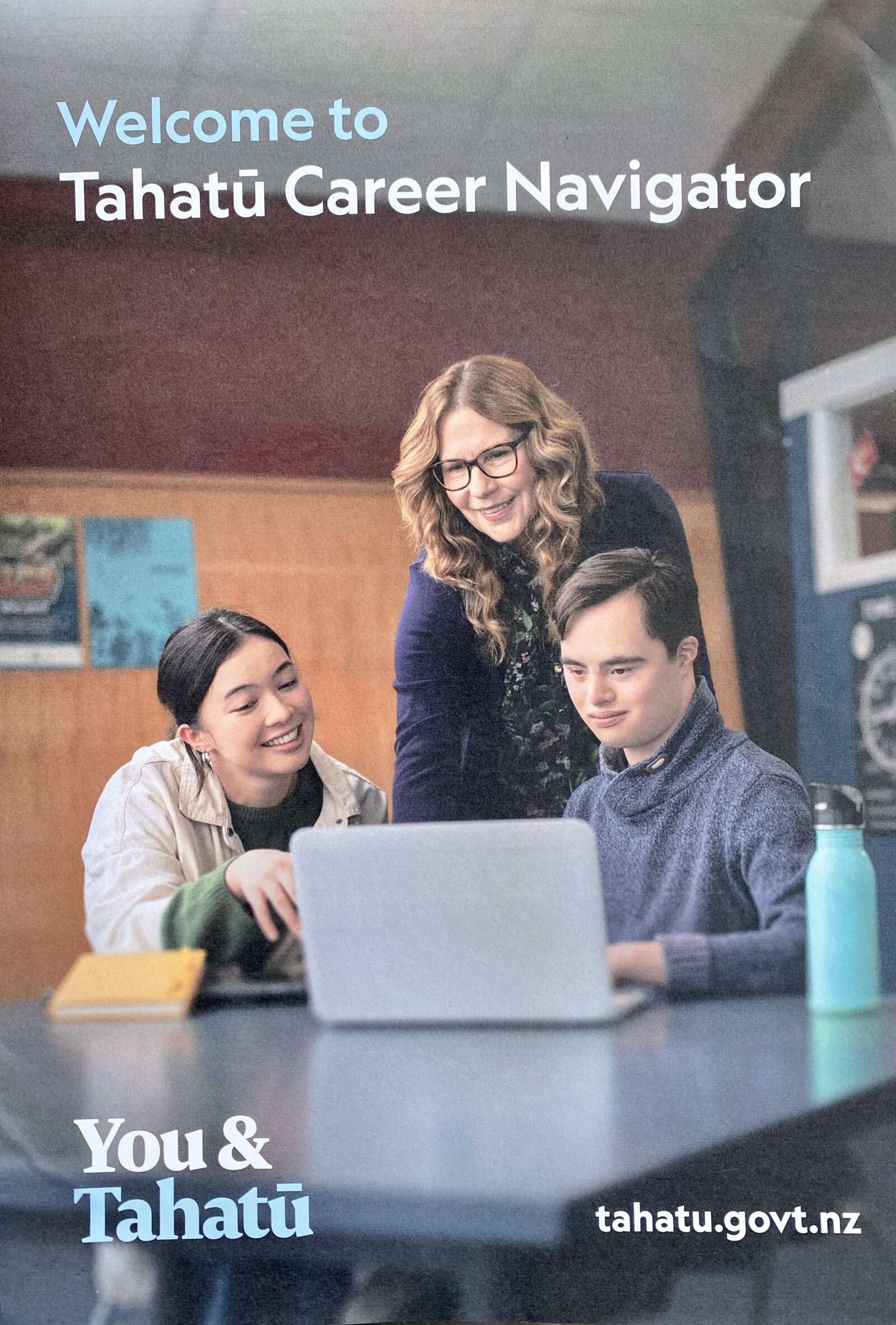 Group at a table looking at a laptop