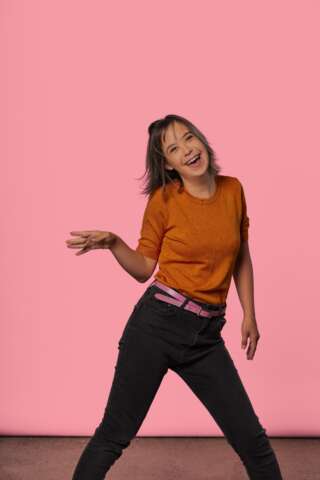 Image of Molly posing on a pink background